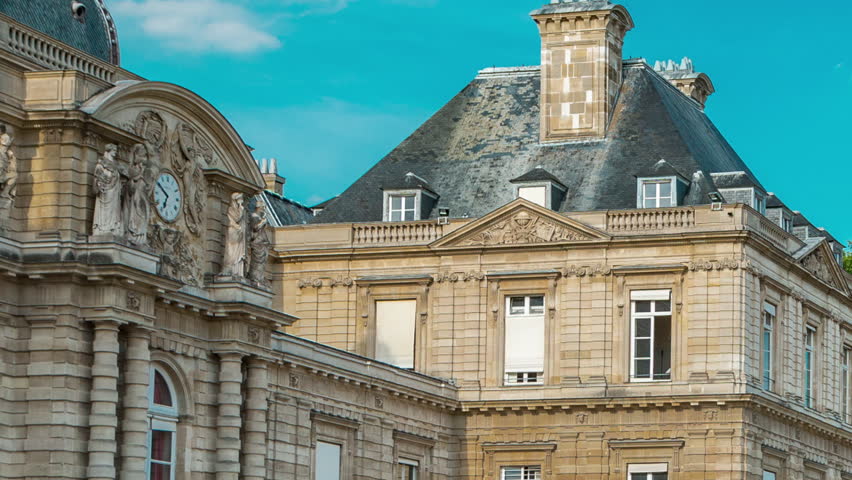 Luxembourg Palace with watch and park timelapse hyperlapse in Paris, the Jardin du Luxembourg, one of the most beautiful gardens in Paris. France.