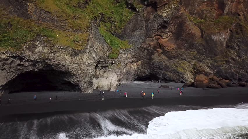 Aerial drone footage of Basalt cave with basalt columns at Reynisfjara Beach near Vik in Iceland. Black sand beach. High quality 4k footage Royalty-Free Stock Footage #1102434041