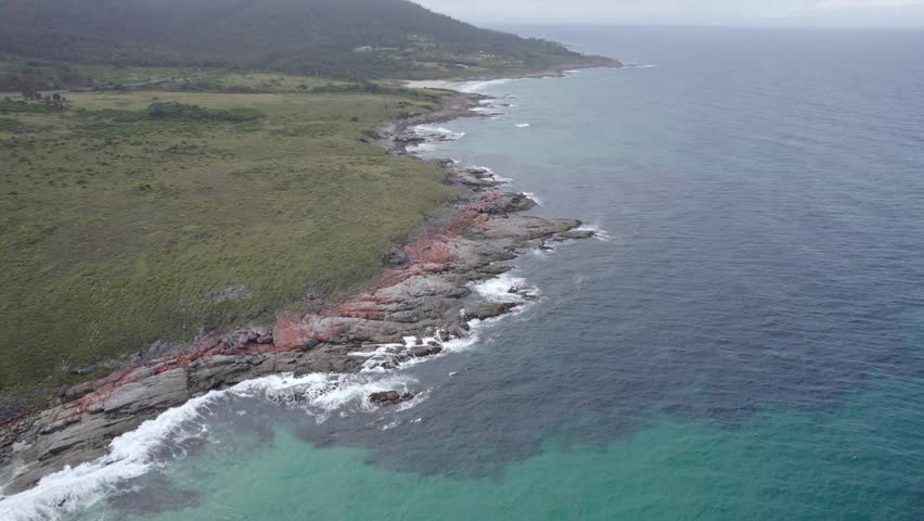 Aerial View of Tasman Sea, Green Meadow And Rocky Coastline Near Beaumaris Beach, Tasmania, Australia.