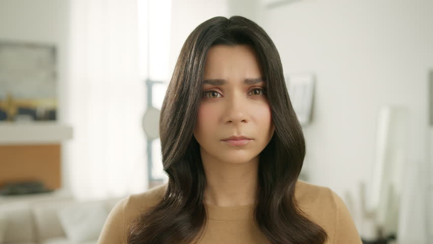 Upset female face of sad stressed hispanic girl with broken heart. Crying woman looking at camera with resentful offended facial expression worry about life problem. Series of face emotions close up | Shutterstock HD Video #1102434687