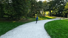 Slowmotion video of an athlete, during a morning run in the park. Germany