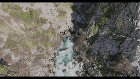 Aerial footage of river-waterfall coming out of the mountains
Video with a transition from the waterfall view to the road
Mountain goats walking along the road with cars
