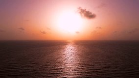 Aerial static view of beautiful pink sunset over the calm sea water. The sun sits over the horizon - Powered by Shutterstock - Get 15% off with code: PIKWIZARD15