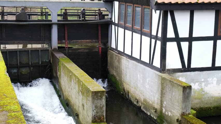 SLUPSK, POLAND Weir of the Castle Mill. Slupia river old water mill. Waterfall in early spring. 