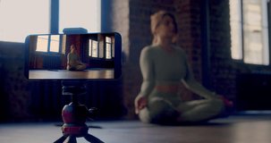 Meditation online streaming - yoga instructor leads an online broadcast of meditation. Modern technologies as a way to improve yourself from anywhere in the world. Slow motion 4k video.