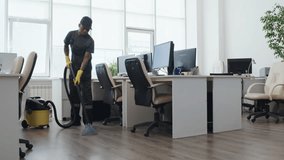 Slow motion long shot of young Black man and Caucasian woman in uniform cleaning modern open plan office - Powered by Shutterstock - Get 15% off with code: PIKWIZARD15