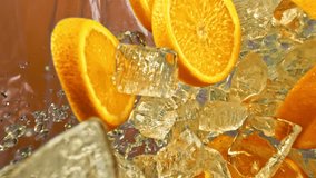 Sweet juice citrus orange slices and ice cube fall or explode on orange background in slow motion 1000fps. Orange and fly ice cube or water splash or pouring drops juice in super slow motion 1000 fps - Powered by Shutterstock - Get 15% off with code: PIKWIZARD15