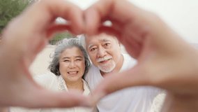Portrait of Happy Asian family senior couple with gray hair taking picture together at tropical beach at summer sunset. Retired elderly people enjoy outdoor lifestyle travel ocean on holiday vacation. - Powered by Shutterstock - Get 15% off with code: PIKWIZARD15