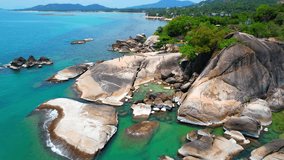 Hin Ta Hin Yai is a famous rock formation located on Koh Samui, Thailand. As seen from a drone, the rocks appear as two giant boulders protruding from the turquoise waters of the Gulf of Thailand.

