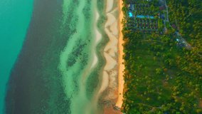 White sand beach bordered by lush greenery and the sparkling turquoise waters. Underwater sand dunes and beautiful sandbar. aerial view captures the entire stretch of the beach. Koh Samui, Thailand
