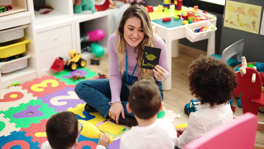 Woman and group of kids having vocabulary lesson with word cards at kindergarten Royalty-Free Stock Footage #1102453947
