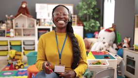 African woman preschool teacher on a video call using headset at kindergarten