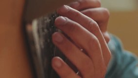 Vertical video, Close-up of the hands of young unidentifiable man working on laptop