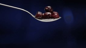 static macro shot of several cherries being dropped out of spoon - Powered by Shutterstock - Get 15% off with code: PIKWIZARD15