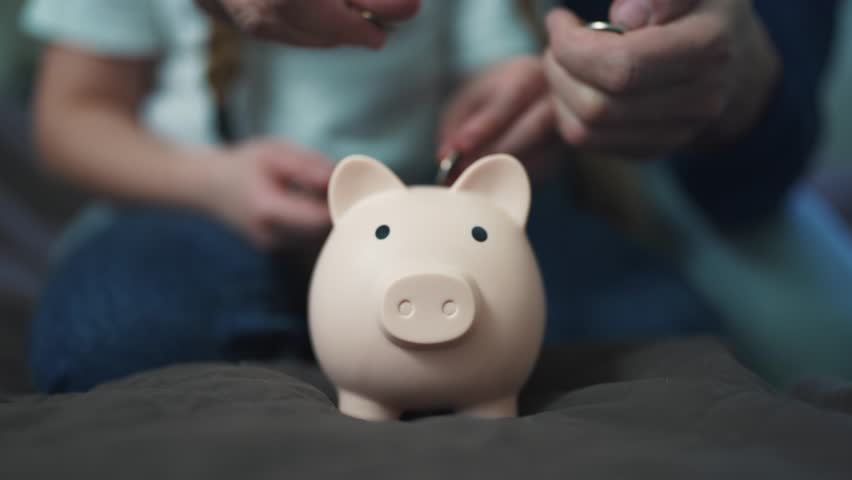 family saving coins in piggy bank. happy family business concept. father and daughter save coins in a piggy bank. investment business concept. saving teach money happy family father and daughter Royalty-Free Stock Footage #1102464697