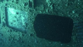 Vertical video, Scuba diver swim inside hold of ferry Salem Express shipwreck, Backlight, Slow motion