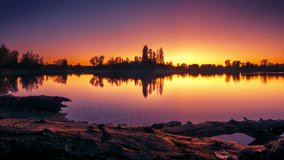Day to night time lapse at a scenic lake, showing a colorful sunset with romantic colors, transitioning to a beautiful night with star trails - Powered by Shutterstock - Get 15% off with code: PIKWIZARD15