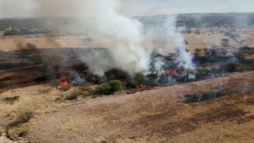 Drone shot circling a wildfire in a remote prairie area of United states of America