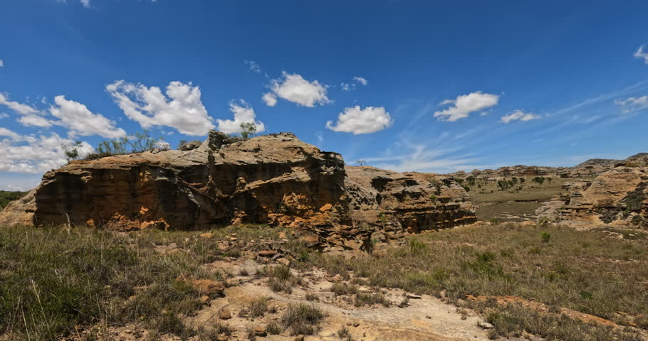 Panorama camera move in Isalo National Park. Wilderness landscape with water erosion into rocky outcrops, plateaus, extensive plains and deep canyons. Beautiful Madagascar panorama landscape.
