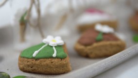 A close up view of a dish full of heart shaped Valentine's Day sugar cookies with various designs and sprinkles - Powered by Shutterstock - Get 15% off with code: PIKWIZARD15
