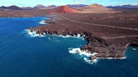 Volcanic Lanzarote island scenery. aerial drone video of Los Hervideros caves and cliffs and Red mountain . popular tourist destination Canary islands