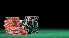 Game of dice. Gambling in the casino. Throws red dice, slow motion. Red and black chip stacks on a green gaming table. Betting. Fortune, risk and win. - Powered by Shutterstock - Get 15% off with code: PIKWIZARD15