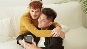 couple embracing and smiling while taking selfie together