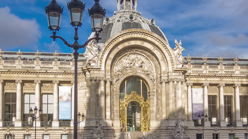 The exterior including the dome of the Petit Palais museum timelapse hyperlapse in Paris France. View from Grand Palais with parking and traffic on a road. Blue cloudy sky at summer day Royalty-Free Stock Footage #1102484341