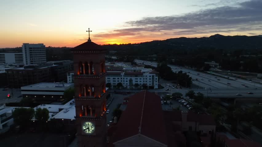 St. Andrew's Catholic Church aerial pass by bell tower at sunset in Pasadena Royalty-Free Stock Footage #1102489657