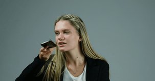 Young blonde woman joyfully uses her smartphone when suddenly the connection or mobile stops working. She, frustrated, gets very angry and wants to smash everything.