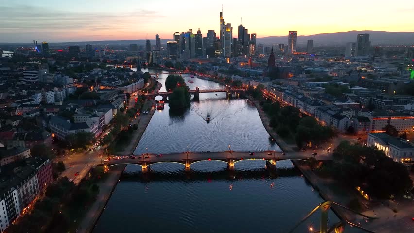 Dolly Flight through Frankfurt am Main, Germany Skyline New Skyscrapers Urban Canyon in Sunset or Sunrise Light, Aerial Pedestal in Establishing Night Drone Shot. Glowing street lights