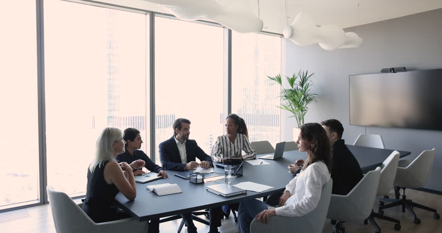 Negotiations process of multi ethnic staff, businesspeople gathered in skyscraper office. Millennial team member, share strategy, discuss commercial deal with partners in boardroom. Business meeting Royalty-Free Stock Footage #1102501787