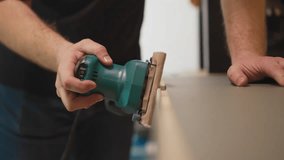 Carpenter polishes wooden furniture detail with manual tool in workshop closeup. Worker processes item at production plant. Handwork instrument - Powered by Shutterstock - Get 15% off with code: PIKWIZARD15