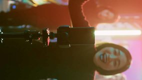 Vertical video: Woman filming vlog for social media, using smartphone at nightclub on dance floor. Young adult recording fun video of friends dancing and partying together, entertainment. Handheld - Powered by Shutterstock - Get 15% off with code: PIKWIZARD15