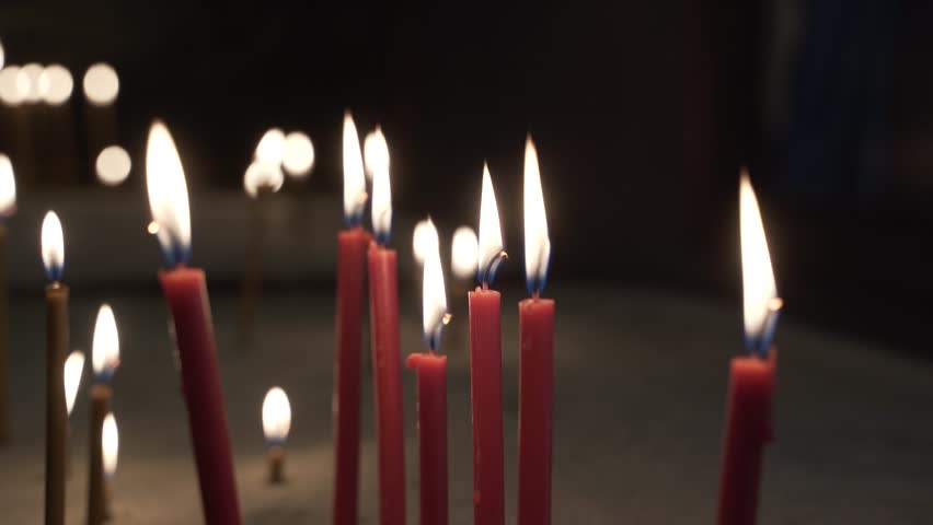 The fire of church candles in the Orthodox, ancient Armenian temple. The most sacred places for all Christian believers in the world. Royalty-Free Stock Footage #1102506837
