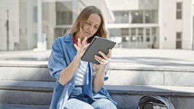 Young blonde woman student using touchpad sitting on stairs at university - Powered by Shutterstock - Get 15% off with code: PIKWIZARD15