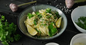 Eating Lemon pasta, Pasta al Limone, person tasting spaghetti with white cream sauce, lemon zest and parmesan cheese, using fork and spoon, 4k footage, high quality horizontal video clip