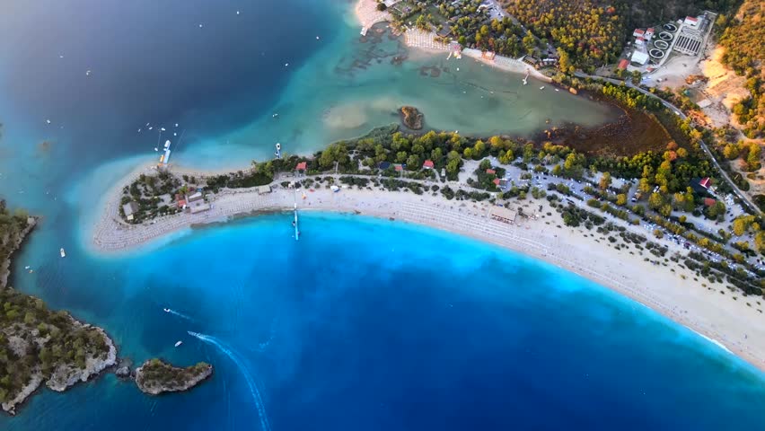 Aerial drone footage capturing the beauty of Kumburnu Beach in Ölüdeniz, Fethiye, Turkey, showcasing the turquoise waters, coastline, and serene atmosphere of this popular summer destination. Royalty-Free Stock Footage #1102510641