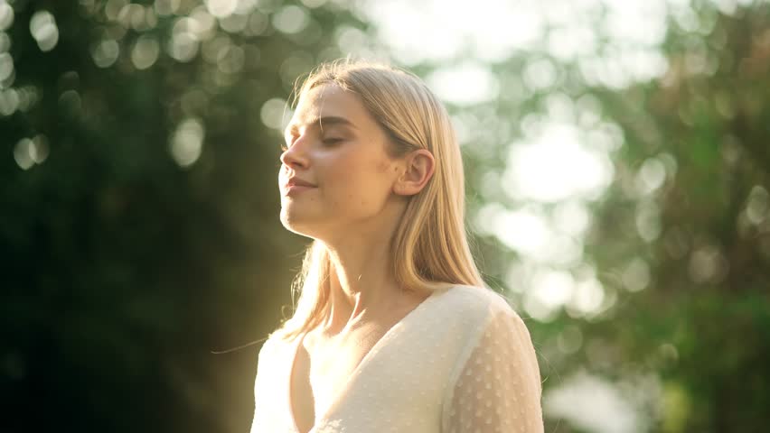 Portrait of Young Beautiful Woman with Long Blond Hair Exhaling Fresh Air, Taking Deep Breath and Reducing Stress Royalty-Free Stock Footage #1102511373