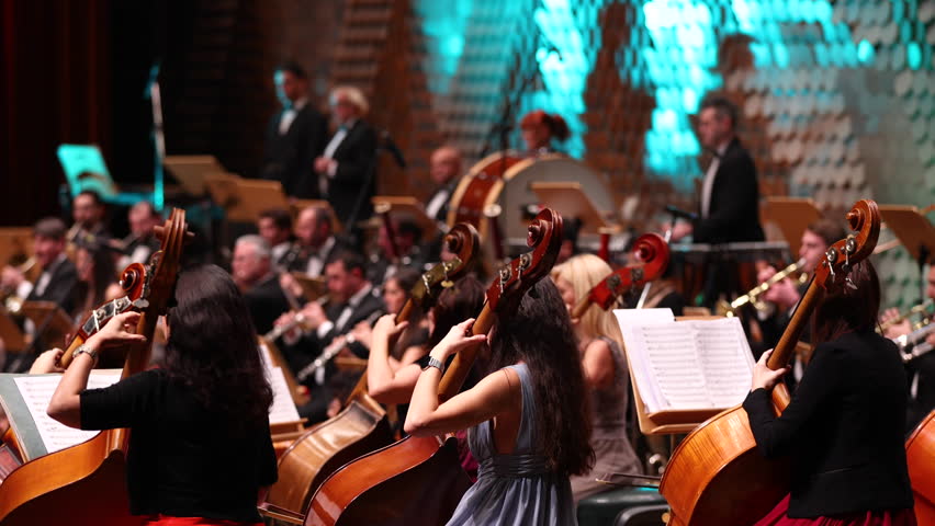 An orchestra is a large instrumental ensemble typical of classical music, which combines instruments from different families. Royalty-Free Stock Footage #1102514895