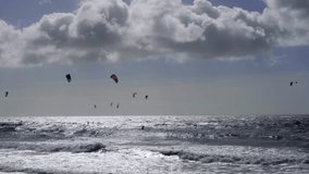 Kite surfing on windy day in rough sea on Southbourne Beach, Dorset