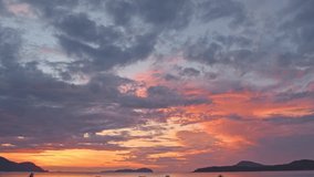 
Majestic sunset or sunrise landscape Amazing light of nature amazing cloud scape sky and colorful clouds moving away rolling. 
colorful dark sunrise clouds above the islands. 4K video cloudscape. 
