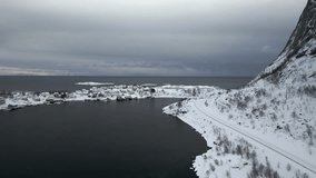 Reine village with snow in Lofoten Islands archipelago, Norway. Aerial birdseye and sky for copy space