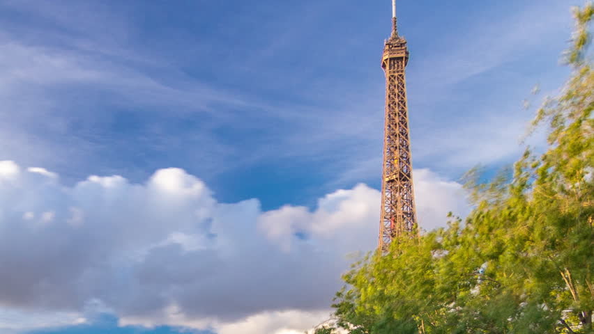 Eiffel Tower with boats at the evening timelapse hyperlapse Paris, France. Aerial view from Bir-Hakeim bridge before sunset. Blue cloudy sky at summer day
