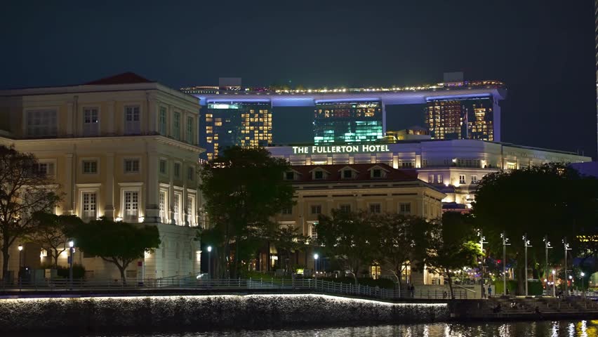 SINGAPORE, SINGAPORE - Mar 14, 2023: Singapore at night. Views of Marina Bay, hotels and buildings downtown. Collyer Quay area.