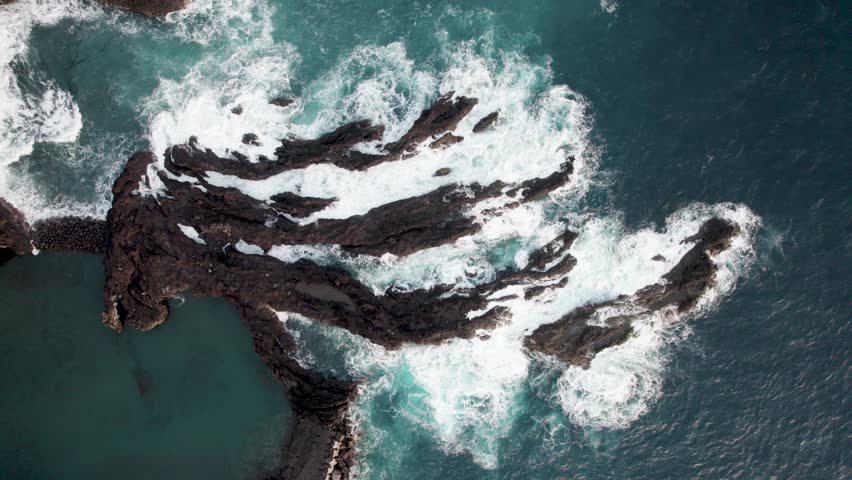 Aerial topdown of waves hitting rocks on coasltine, Madiera, Portugal