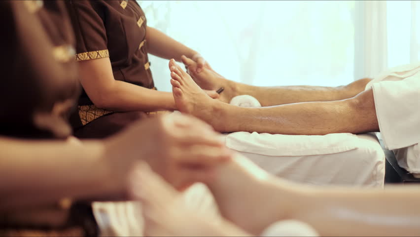 Masseuse service foot massage to woman customer. Relaxation foot massage in spa salon. Professional masseuse acupressure massage on feet of customer. Selective focus. Royalty-Free Stock Footage #1102539093