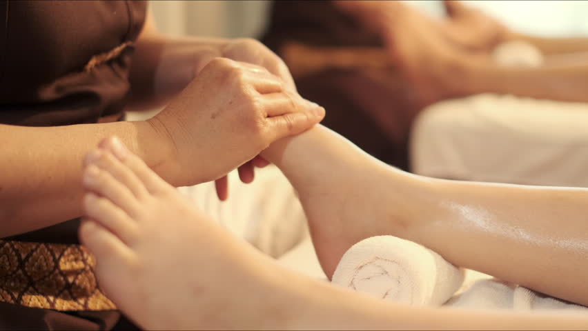 Relaxation foot massage in spa salon. Professional masseuse acupressure massage on feet of customer. Masseuse service foot massage to woman customer. Royalty-Free Stock Footage #1102539109
