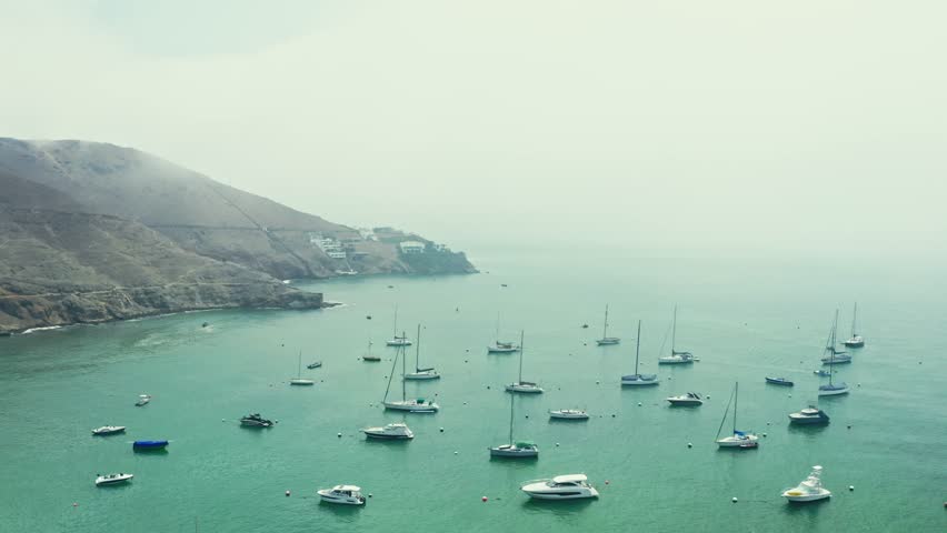 Aerial view of the bay, marina and buildings of Ancon - Lima, Peru; The beach and some exterior buildings in Ancon.