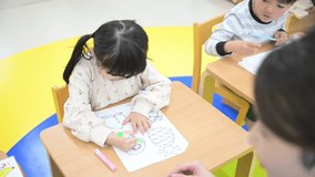Video of children girls drawing in kindergarten and nursery school